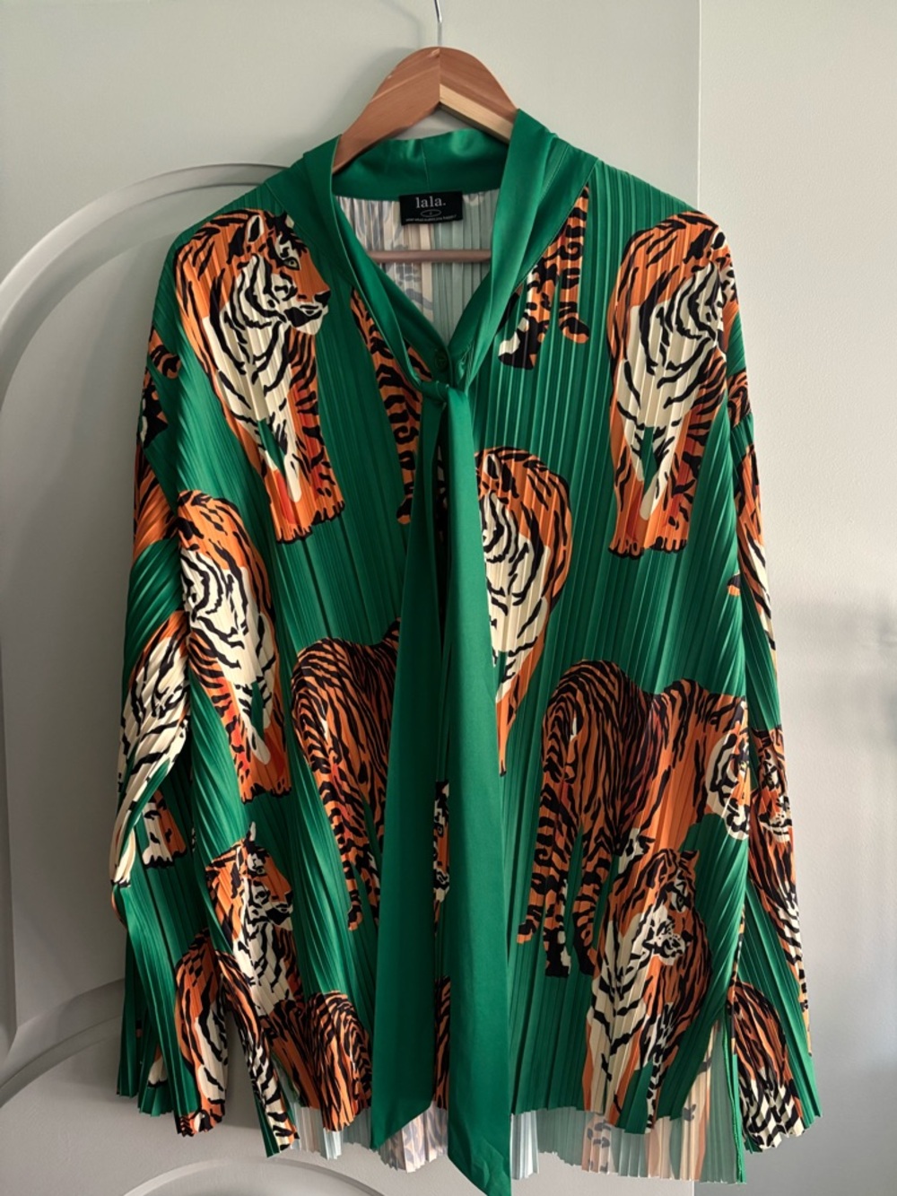 Dressed in LALA Tiger and Green Pleated Top with neck tie.